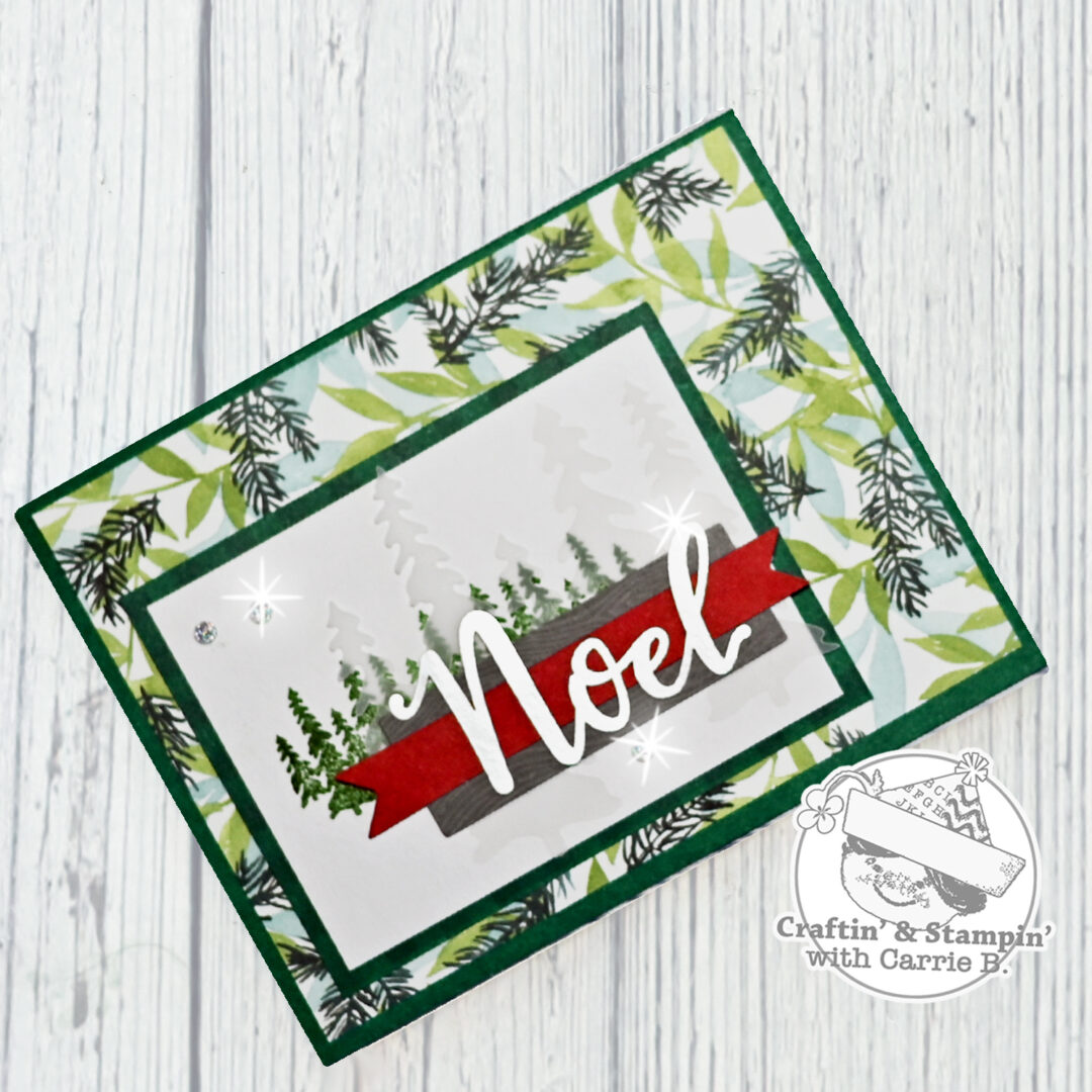 A custom paper card with a forest that reads Noel